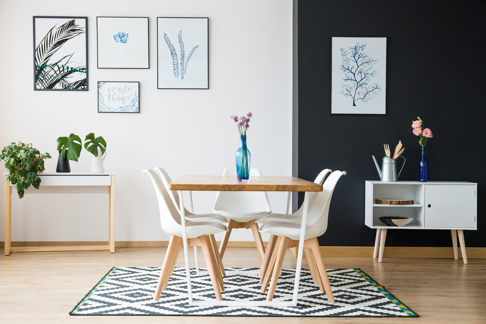 Wooden table with flowers on black and white carpet